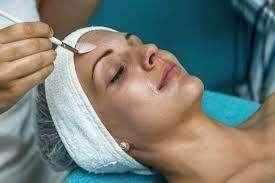 Woman undergoing a glycolic acid peel treatment for skin rejuvenation and exfoliation