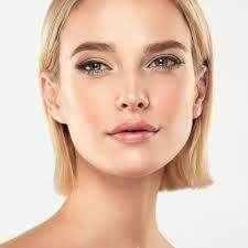 Woman showcasing radiant skin while using niacinamide for wrinkle reduction