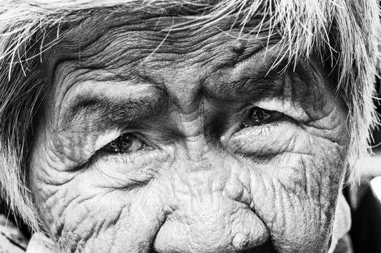 A black and white photo of an old woman