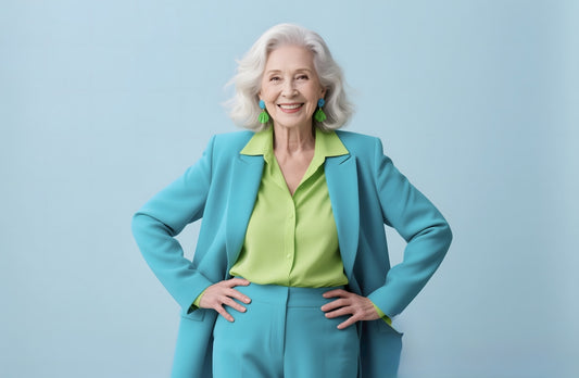 An elegant senior woman confidently poses for a photo.