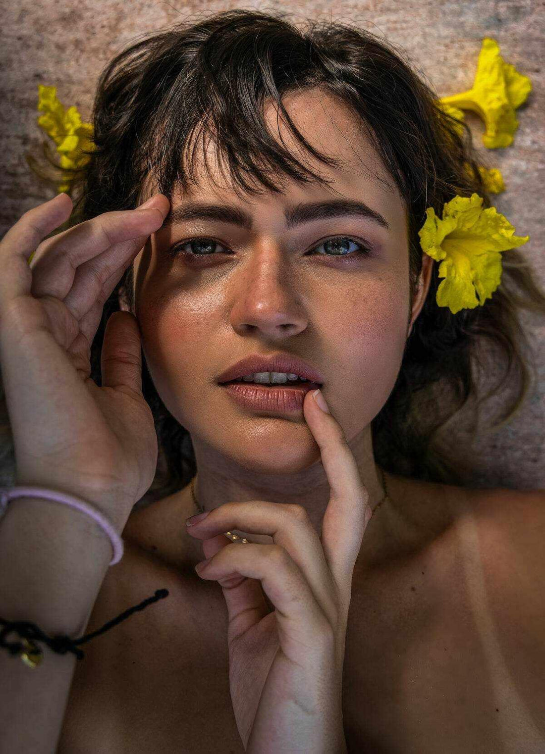 Close-up of a woman showcasing natural beauty, emphasizing the history of skincare with floral accents